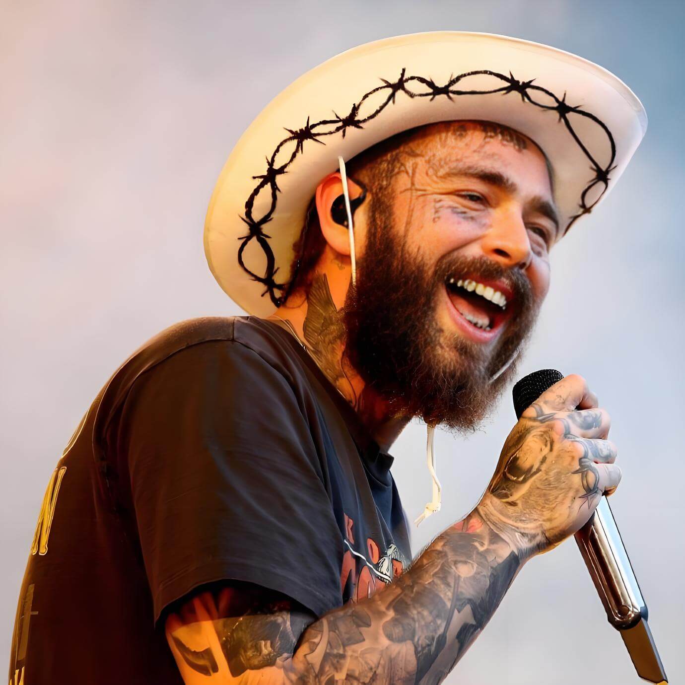 Post Malone hand tattoos with barbed wire and script