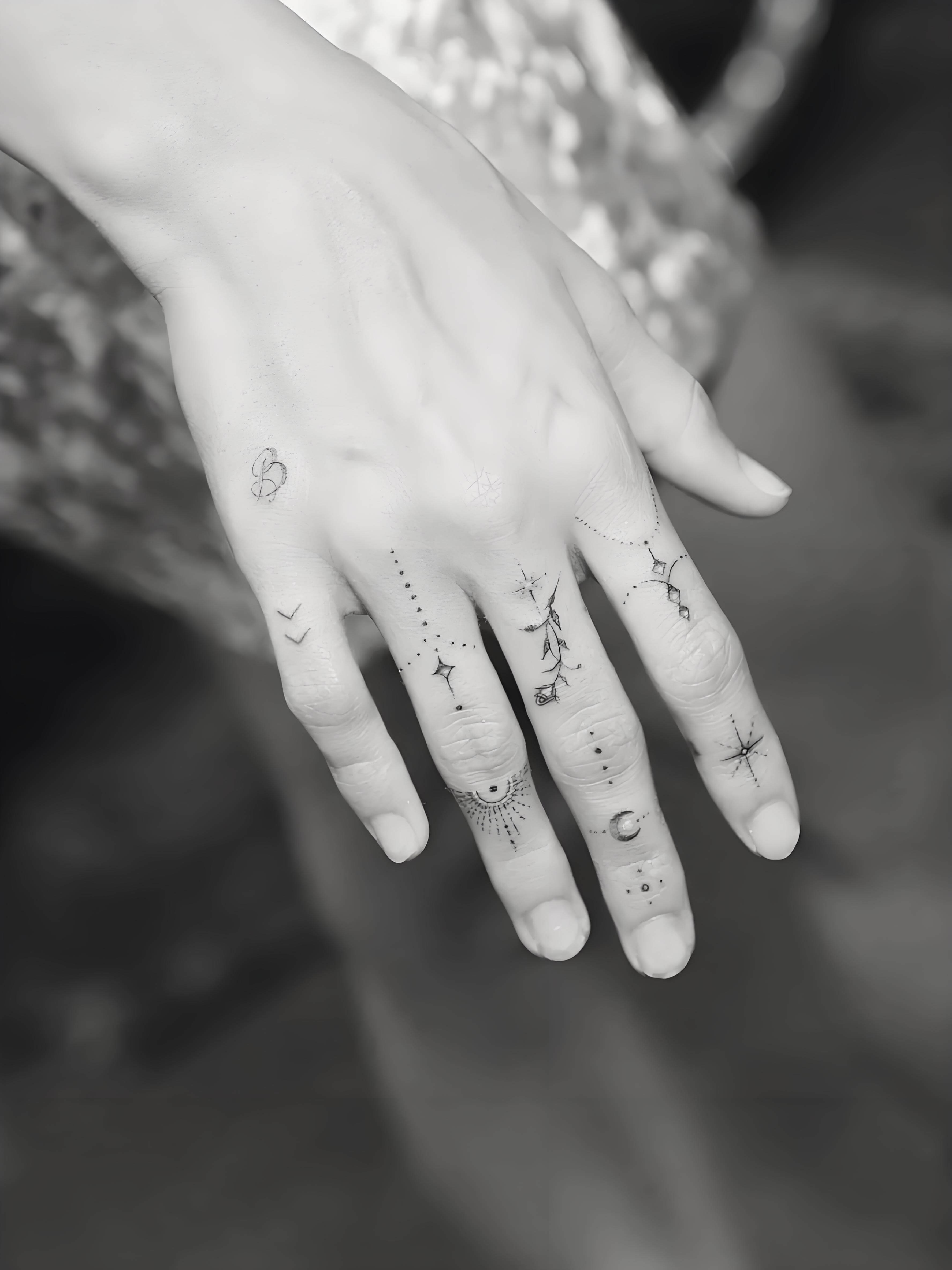 Hailey Bieber small letter tattoo on fingers