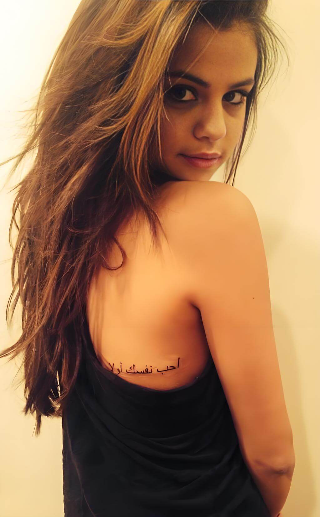 Selena Gomez behind ear music note tattoo