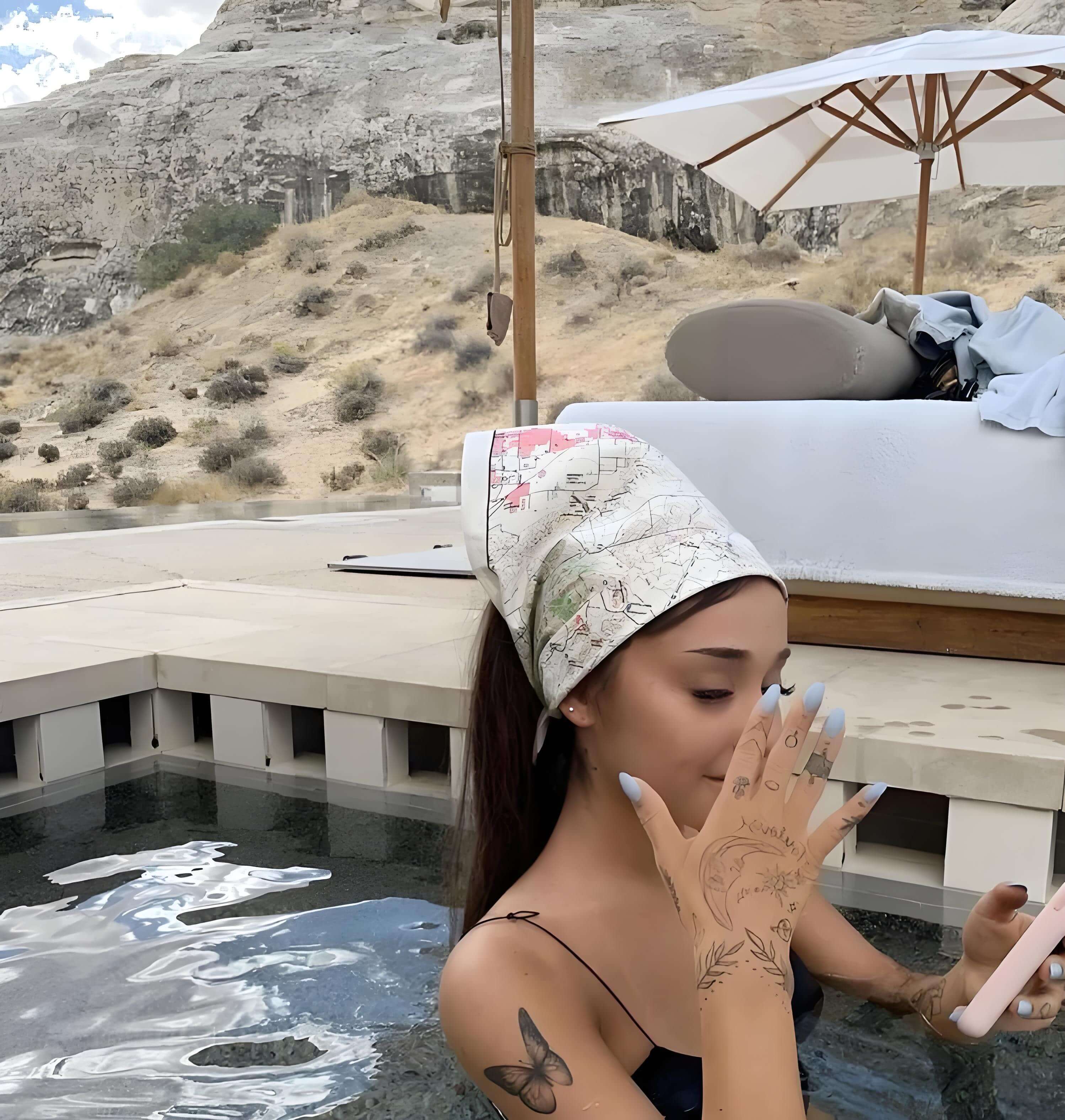 Ariana Grande small tattoos of cloud, heart, and moon